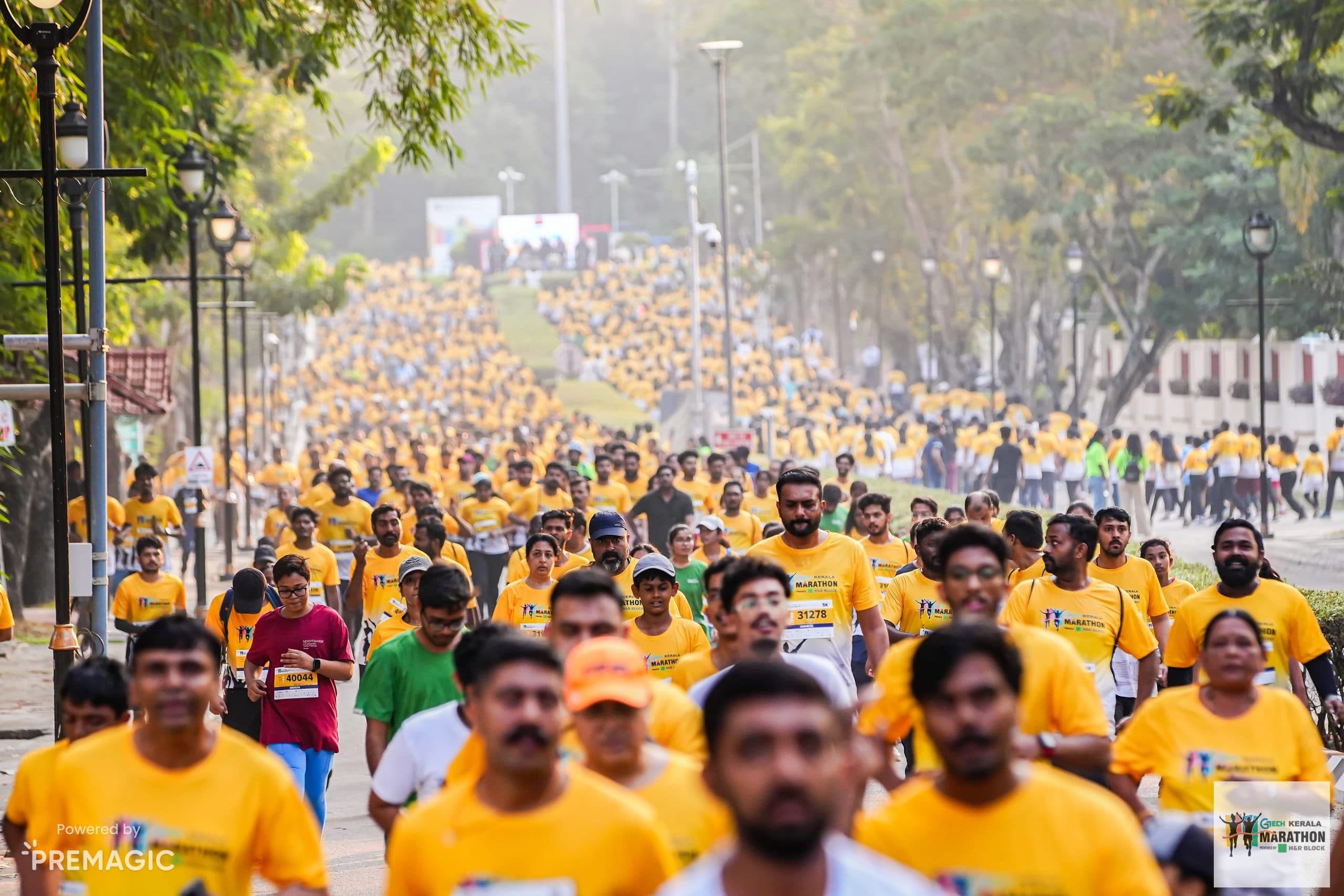 A GTECH Kerala Marathon finisher smiling, a medal ribbon around his neck